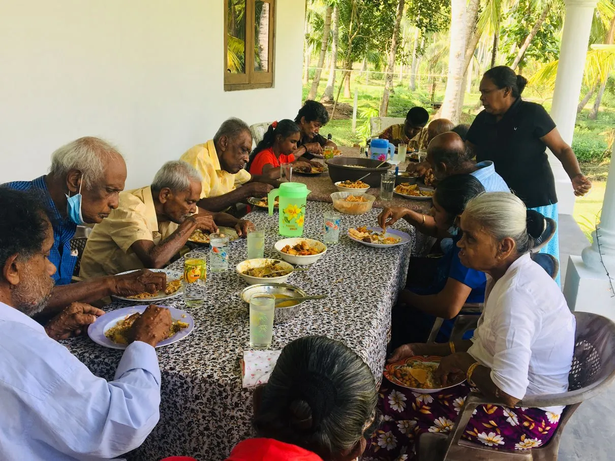 Residents sharing a meal on the veranda